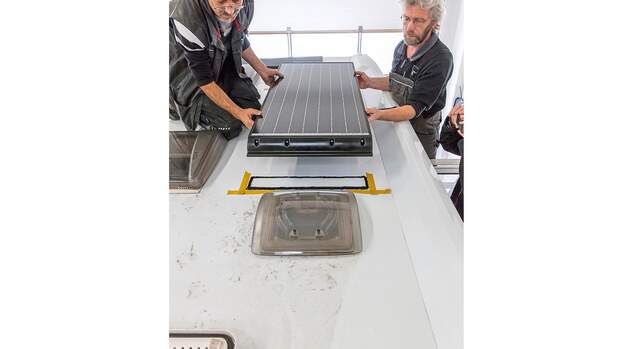 Vorsichtig wird das Solarmodul auf die mit der Dichtmasse behandelte Fläche gehoben und anschließend leicht angedrückt.